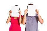 Couple covering faces with paper