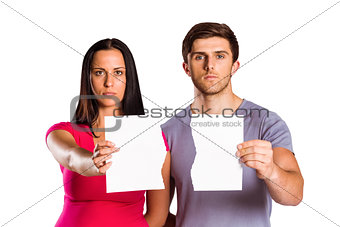 Couple showing broken piece of paper