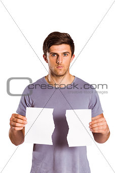 Young man holding ripped paper