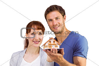 Couple holding a model house