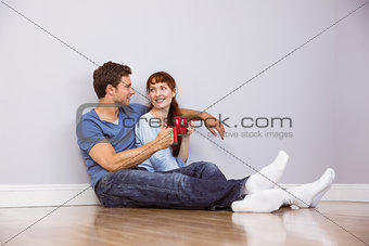 Couple having tea on floor