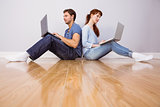 Couple both using laptops separately