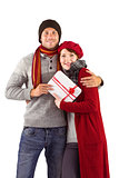 Couple smiling and holding gift
