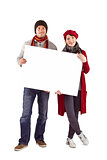 Couple holding a large sign
