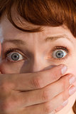 Terrified woman with covered mouth