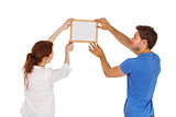 Couple deciding to hang picture