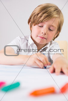 Student using crayons to draw