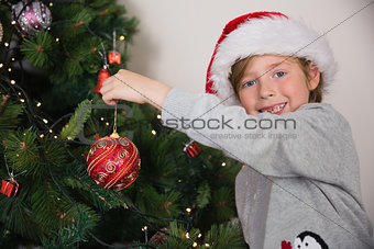 Child hanging up tree decorations