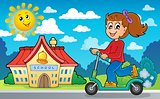 Girl on push scooter near school