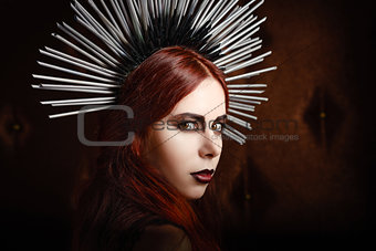 Closeup portrait of cute gothic girl wearing spiked headgear