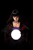 Beautiful witch or fortune teller with a crystal ball 