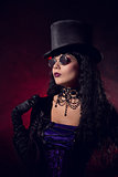 Vampire gothic girl in tophat and round eyeglasses 