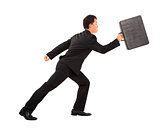 positive businessman running and holding briefcase