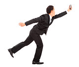 businessman  running busily and holding a smart phone