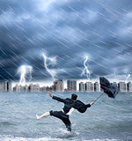 businessman holding an umbrella with thundershower