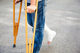 closeup of leg on bandage with crutches