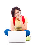 happy young student girl sitting with a laptop