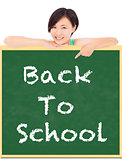 Back to school, young student girl point to blackboard
