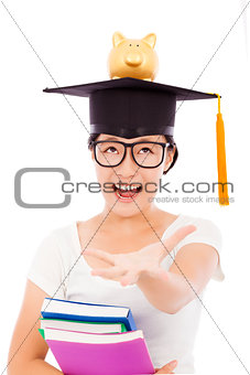 young student stretching hand to grab with piggy bank