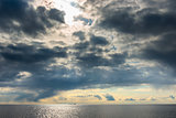 dark cumulus clouds hovering over the sea