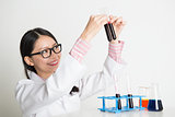 Asian lab worker doing liquid sample analysis