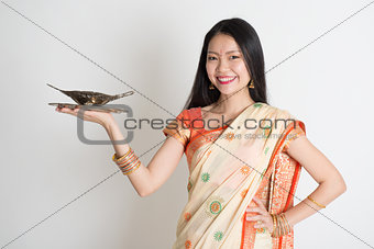 Indian housewife hand holding empty plate 