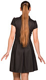 Attractive young woman in black dress. Rear view
