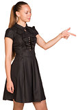 Beautiful business woman in black dress pointing at copy space