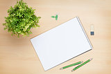 Blank notepad, pen and flower on wooden table