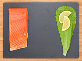 Fresh salmon fish with salad leaf and lemon