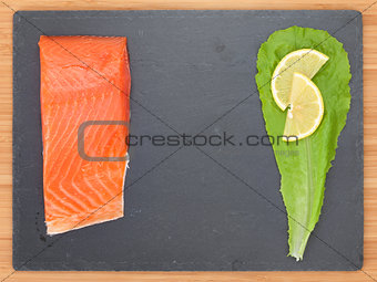 Fresh salmon fish with salad leaf and lemon