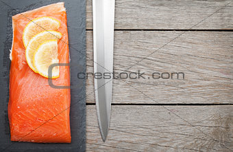 Fresh salmon fish with lemon and japan knife