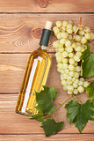 White wine bottle and bunch of white grapes