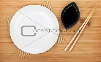 Empty plate, sushi chopsticks and soy sauce