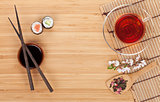 Sushi maki set, herbal tea and sakura branch
