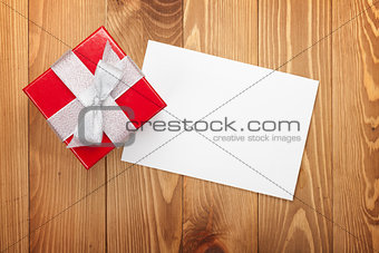 Red gift box over wooden background