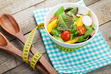 Fresh healthy salad and kitchen utensil