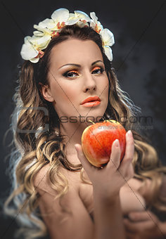 Beautiful seductive woman with apple, conceptual photo