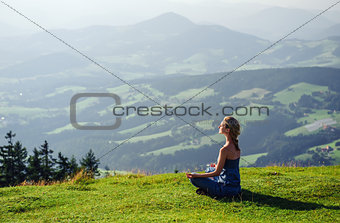 Young woman meditating outdoors