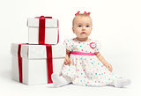 Adorable baby girl with two gift boxes