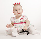 Adorable baby with retro camera over white background