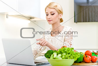 Woman looking for a recipe on the laptop computer