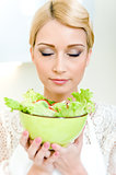 Woman holding a bowl with vegetable salad