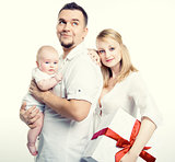 Happy young family with gift box over white background