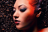 Gorgeous woman's face over coffee beans 