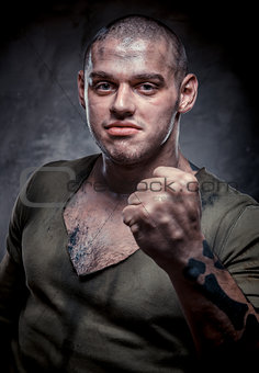 Portrait of young fighter with dirty face and chest