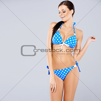 Sexy brunette posing in blue swimsuit