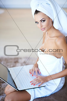 Woman Wearing Bath Towel Using Laptop Computer