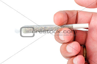 Mans hand holding marijuana joint isolated on white 