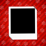 Winter holidays card with blank photo frame on red background